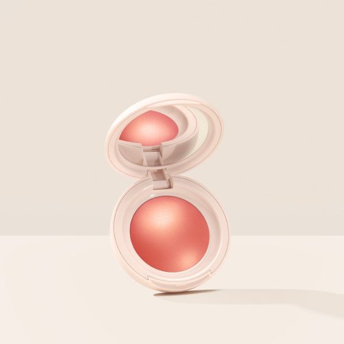 Joy| Rare Beauty's Soft Pinch Luminous Powder Blush in the shade Joy hovering, opened, against a neutral background.